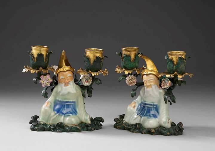 A pair of seated Chinese figures mounted in gilt bronze as candelabra